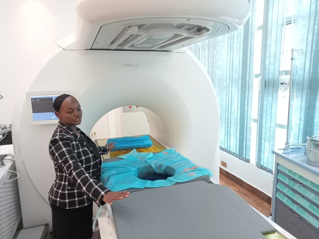 Dr Evelyn Muthoka standing beside the HIFU treatment system
